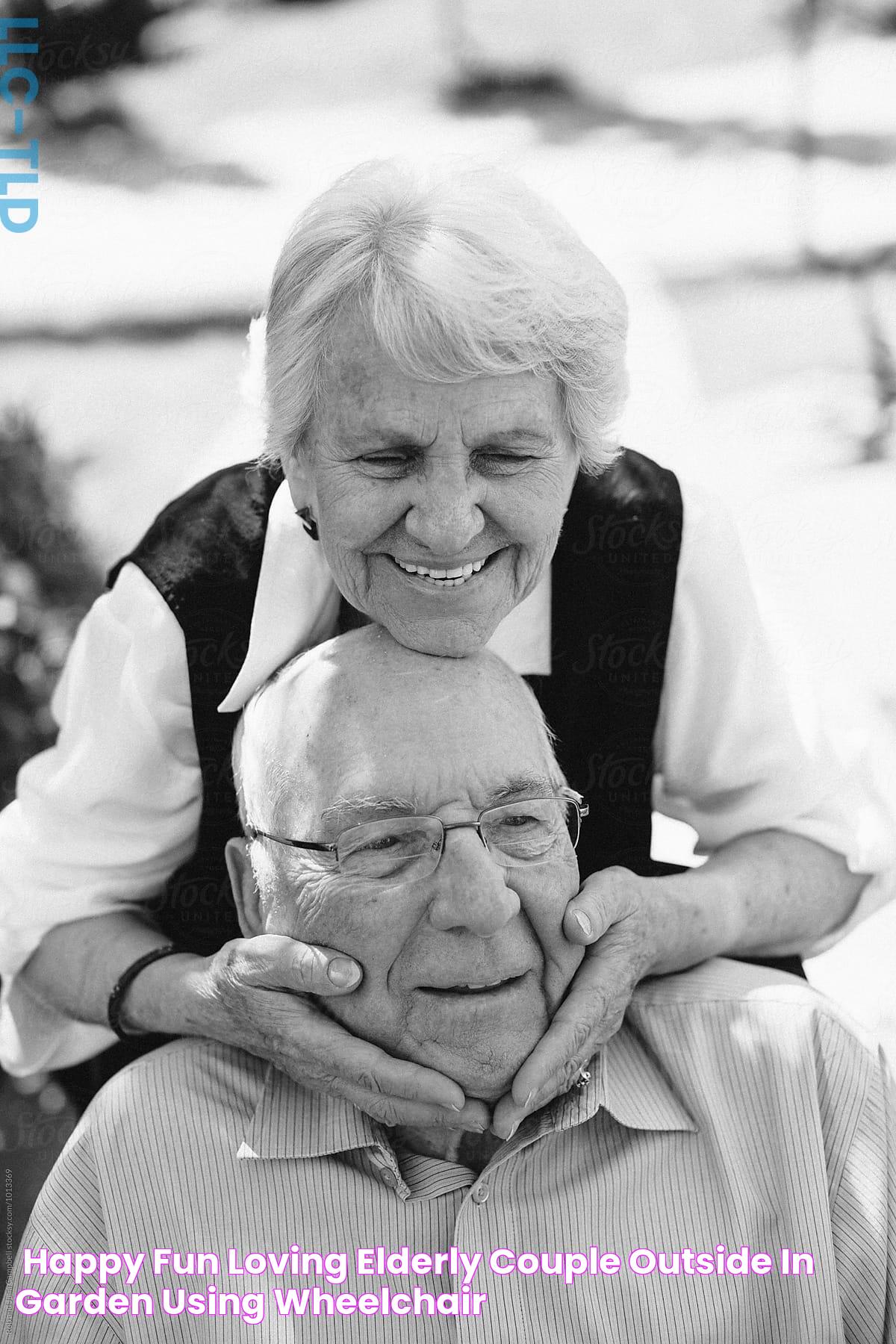 "Happy, Fun Loving Elderly Couple Outside In Garden Using Wheelchair