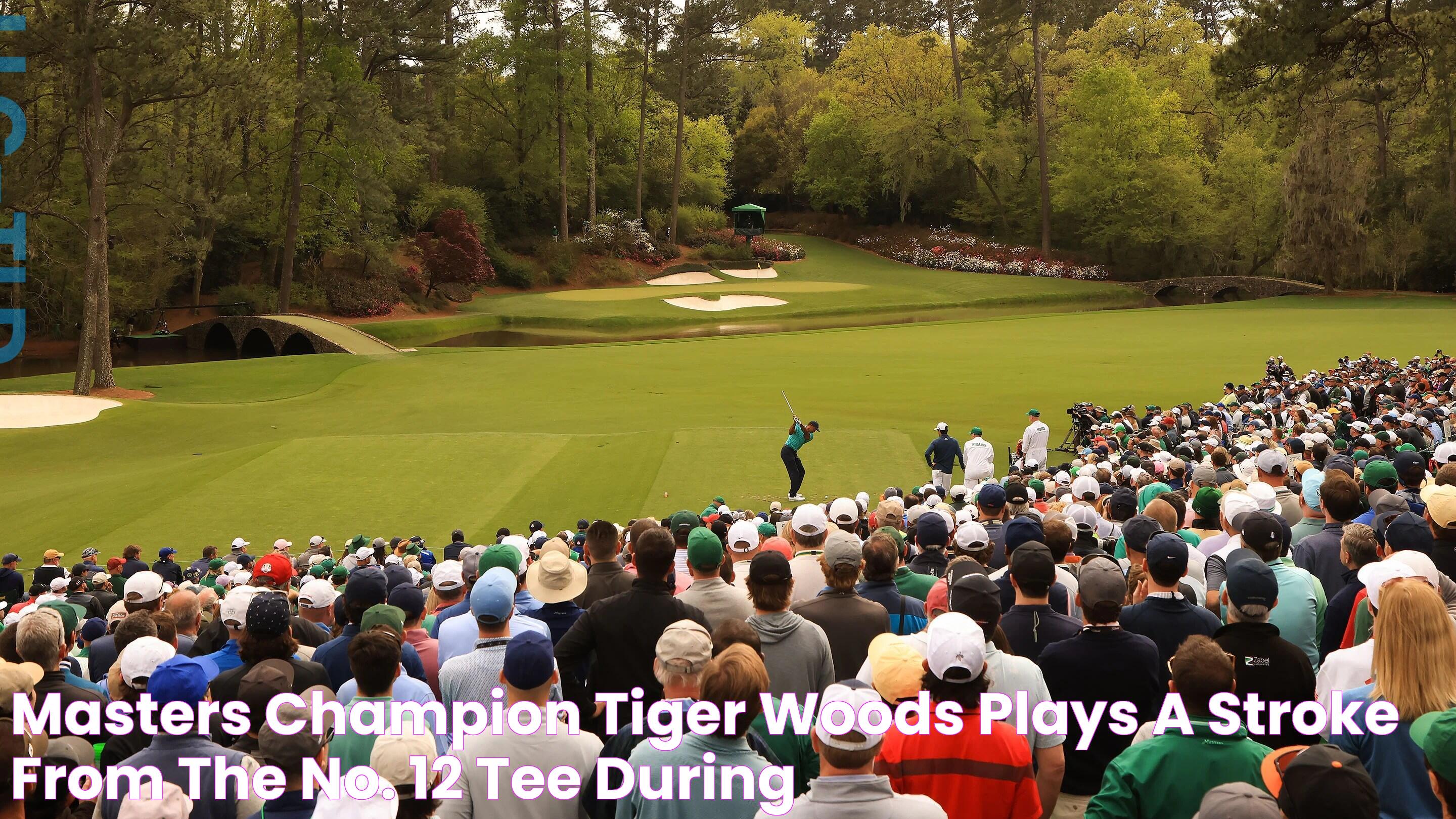 Masters champion Tiger Woods plays a stroke from the No. 12 tee during