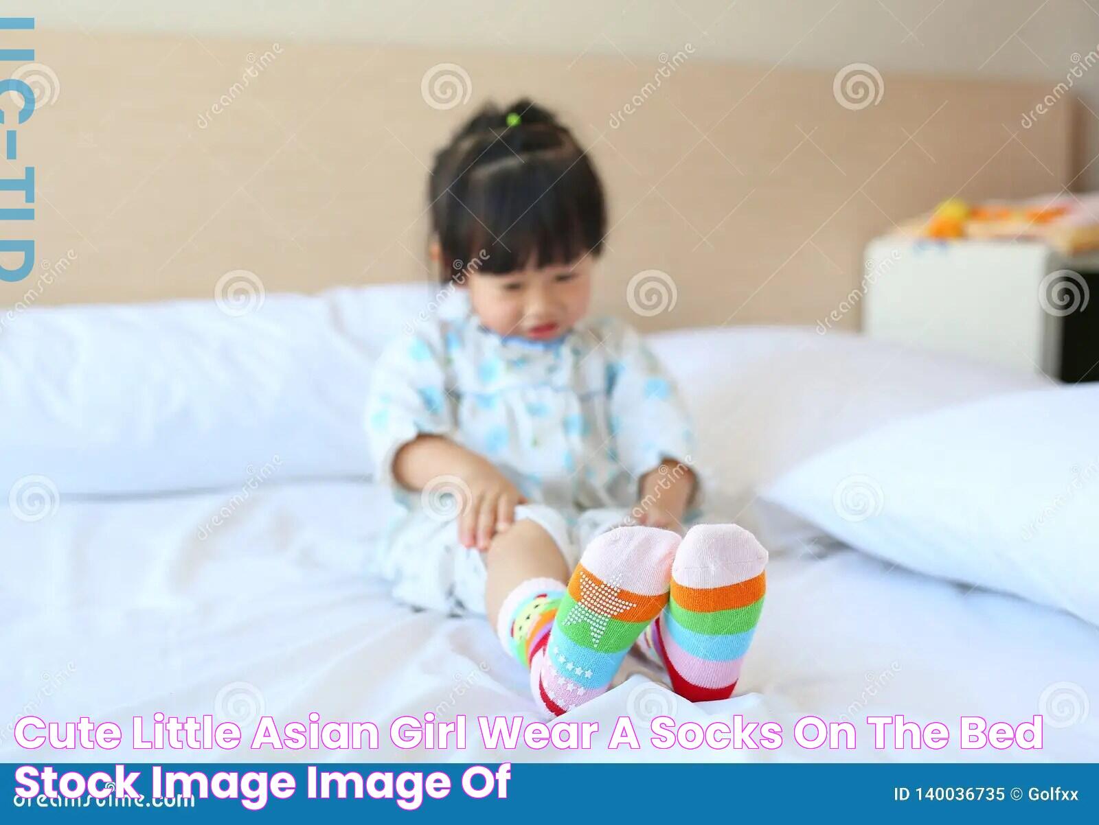 Cute Little Asian Girl Wear a Socks on the Bed Stock Image Image of